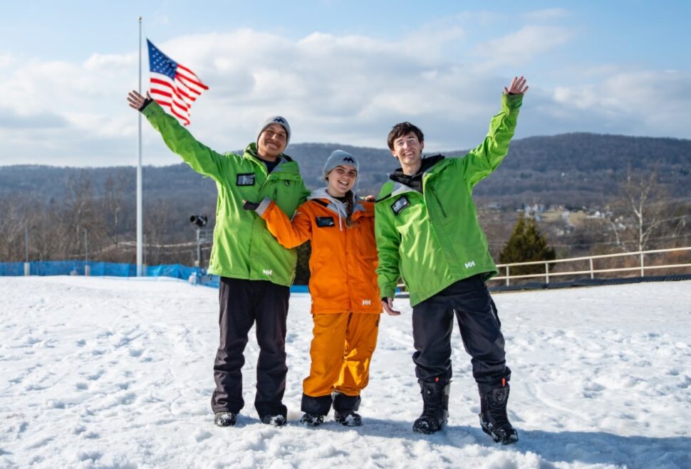Three employees on snow waving